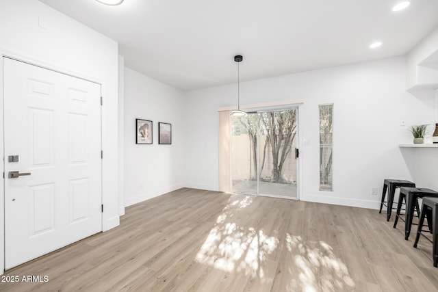 unfurnished dining area with light wood-type flooring