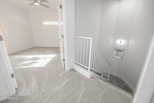 staircase featuring a ceiling fan, carpet flooring, visible vents, and baseboards