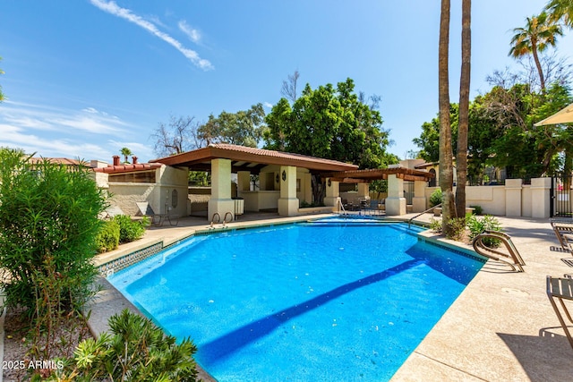 view of pool featuring ceiling fan and a patio area