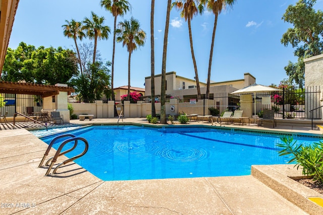 community pool with fence, a pergola, and a patio