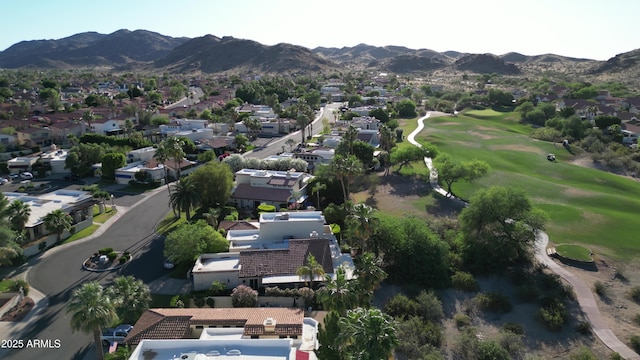 drone / aerial view featuring view of golf course, a residential view, and a mountain view