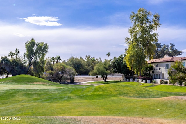 view of home's community with a yard and golf course view