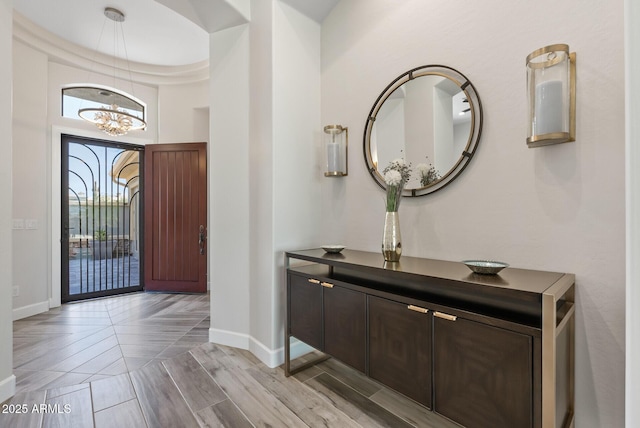 3045 W Feather Sound Dr, Phoenix, AZ 85086 - foyer entrance with a chandelier, baseboards, a high ceiling, and parquet floors