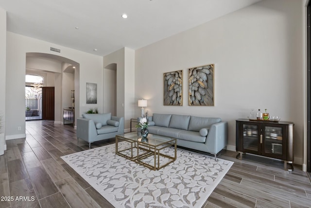 3045 W Feather Sound Dr, Phoenix, AZ 85086 - living area featuring arched walkways, wood finish floors, recessed lighting, and baseboards