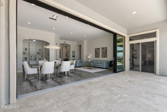 3045 W Feather Sound Dr, Phoenix, AZ 85086 - dining space with arched walkways, a chandelier, and recessed lighting