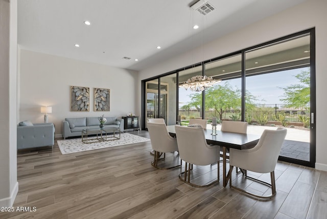 3045 W Feather Sound Dr, Phoenix, AZ 85086 - dining space with wood finished floors, recessed lighting, baseboards, and a chandelier