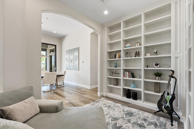 3045 W Feather Sound Dr, Phoenix, AZ 85086 - sitting room featuring arched walkways, baseboards, wood finished floors, and built in features