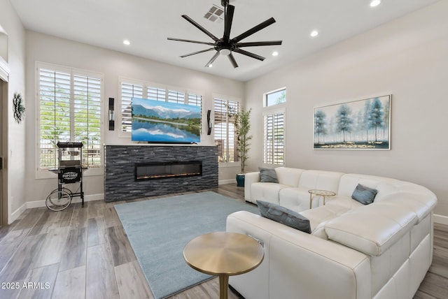 3045 W Feather Sound Dr, Phoenix, AZ 85086 - living room featuring recessed lighting, ceiling fan, a stone fireplace, baseboards, and wood finished floors