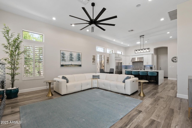 3045 W Feather Sound Dr, Phoenix, AZ 85086 - living room with a ceiling fan, arched walkways, baseboards, plenty of natural light, and recessed lighting