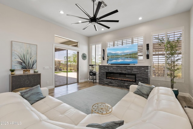 3045 W Feather Sound Dr, Phoenix, AZ 85086 - living room with baseboards, a stone fireplace, wood finished floors, recessed lighting, and ceiling fan