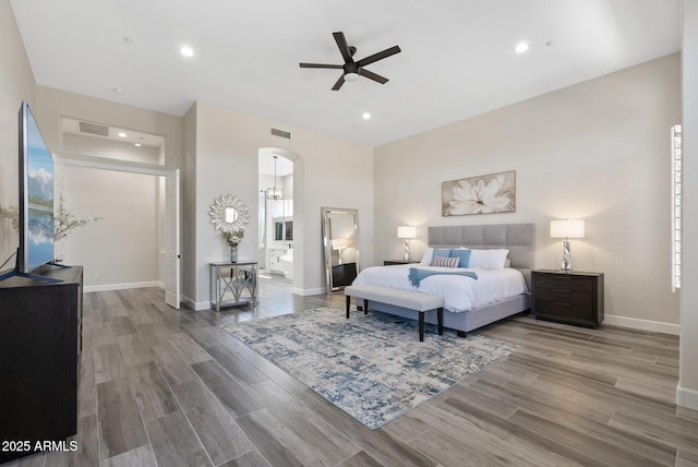 3045 W Feather Sound Dr, Phoenix, AZ 85086 - bedroom featuring wood finished floors, arched walkways, baseboards, recessed lighting, and ensuite bathroom