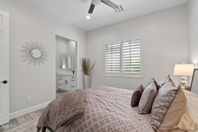 3045 W Feather Sound Dr, Phoenix, AZ 85086 - bedroom with light wood-style flooring, baseboards, ensuite bath, recessed lighting, and a sink