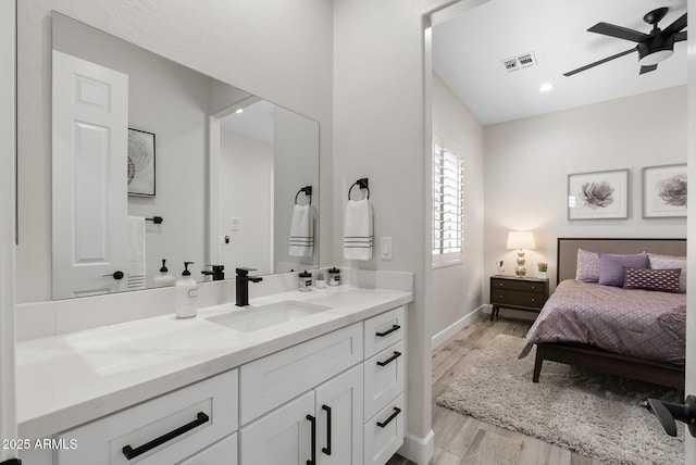 3045 W Feather Sound Dr, Phoenix, AZ 85086 - full bath with vanity, a ceiling fan, wood finished floors, and baseboards