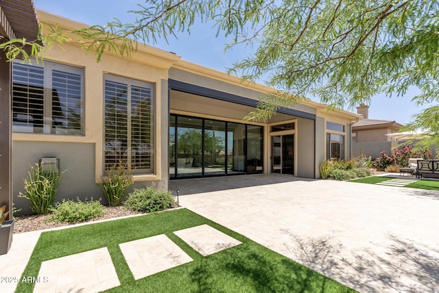 3045 W Feather Sound Dr, Phoenix, AZ 85086 - rear view of property with a patio, stucco siding, and a chimney
