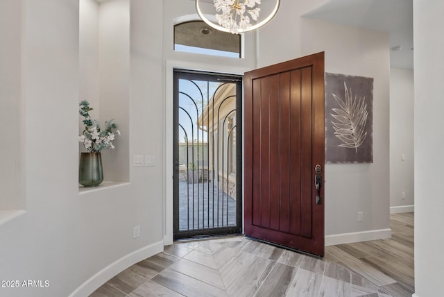 3045 W Feather Sound Dr, Phoenix, AZ 85086 - foyer entrance featuring a chandelier, baseboards, a high ceiling, and wood finished floors