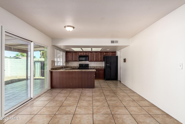 17244 N 36th Ln, Glendale, AZ 85308 - kitchen with black appliances, backsplash, a peninsula, a sink, and light tile patterned floors