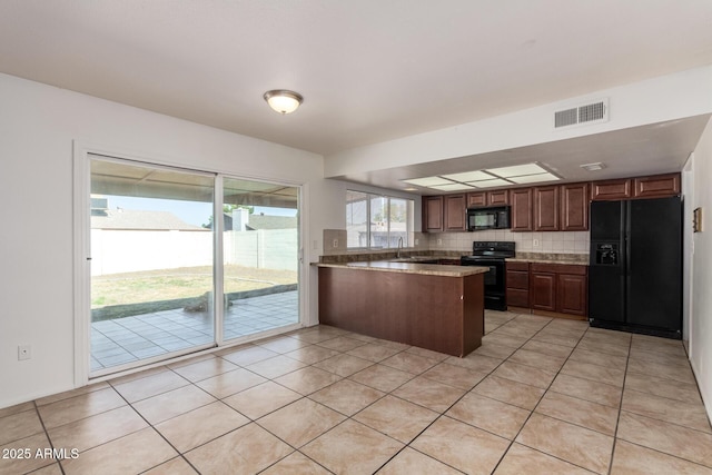 17244 N 36th Ln, Glendale, AZ 85308 - kitchen featuring black appliances, a peninsula, light tile patterned floors, a sink, and tasteful backsplash