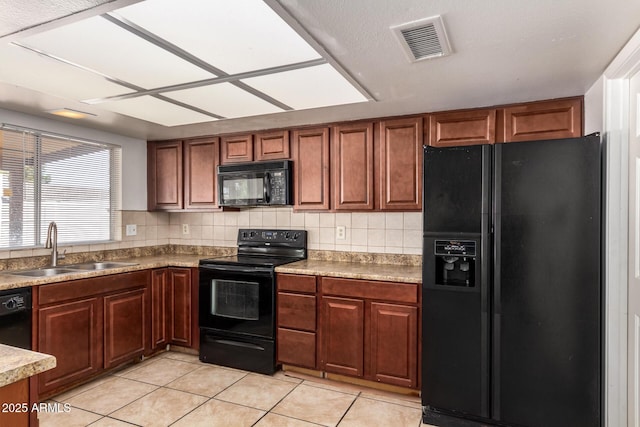 17244 N 36th Ln, Glendale, AZ 85308 - kitchen featuring black appliances, a sink, light tile patterned flooring, backsplash, and brown cabinetry