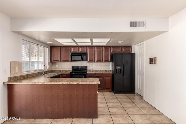 17244 N 36th Ln, Glendale, AZ 85308 - kitchen with black appliances, a peninsula, a sink, and light tile patterned floors