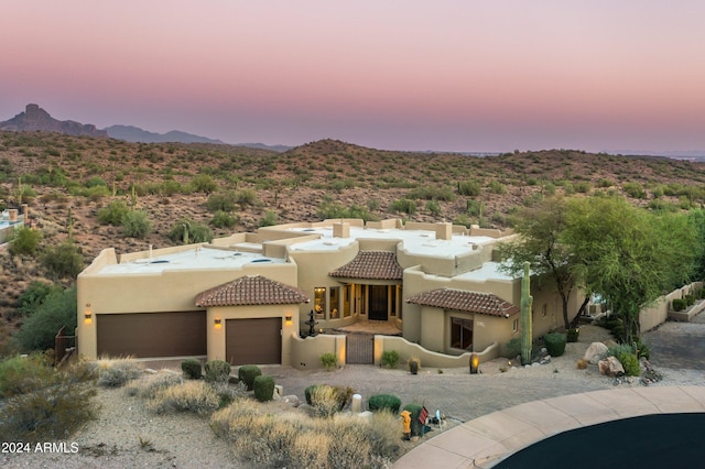 view of front of property with a garage and a mountain view