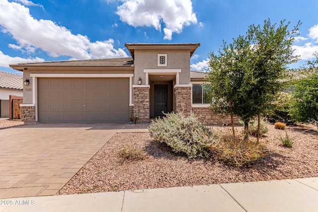 16221 W Prickly Pear Trl, Surprise, AZ 85387 - prairie-style home with stone siding, stucco siding, a garage, driveway, and a tile roof