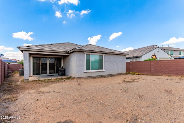 16221 W Prickly Pear Trl, Surprise, AZ 85387 - rear view of house with stucco siding, a tile roof, a fenced backyard, central AC, and a patio area