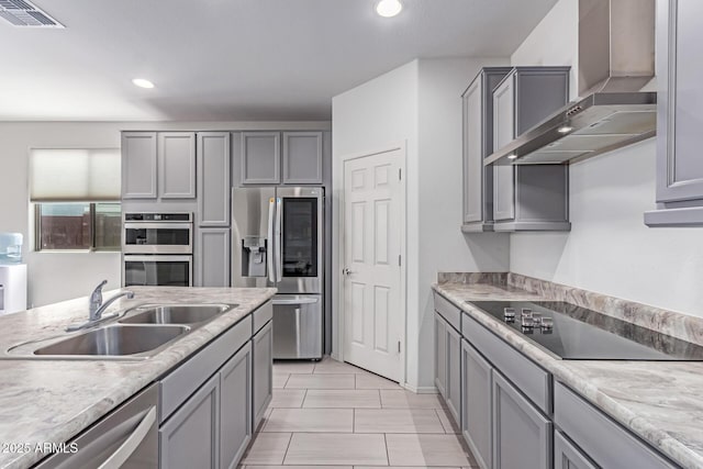 16221 W Prickly Pear Trl, Surprise, AZ 85387 - kitchen featuring wall chimney range hood, stainless steel appliances, gray cabinets, a sink, and light countertops