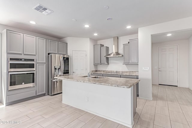 16221 W Prickly Pear Trl, Surprise, AZ 85387 - kitchen featuring wall chimney range hood, stainless steel appliances, gray cabinetry, a sink, and light countertops