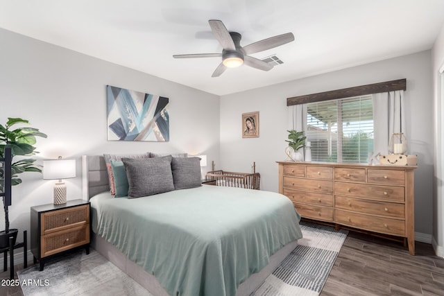 bedroom with ceiling fan and dark wood-type flooring