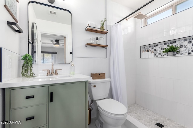 bathroom with a shower with shower curtain, vanity, toilet, and ceiling fan