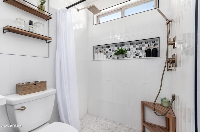 bathroom featuring curtained shower and toilet