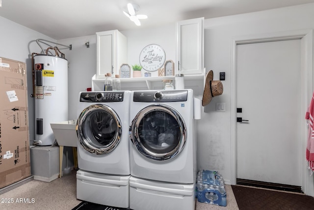 washroom with independent washer and dryer, cabinets, and electric water heater