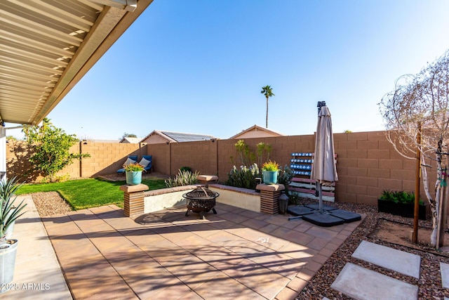 view of patio / terrace with an outdoor fire pit