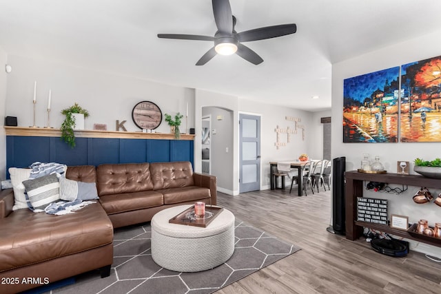 living room featuring ceiling fan and wood-type flooring