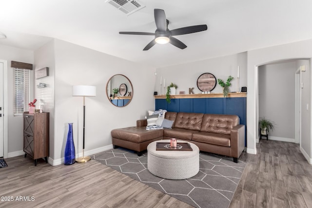 living room featuring ceiling fan and hardwood / wood-style floors