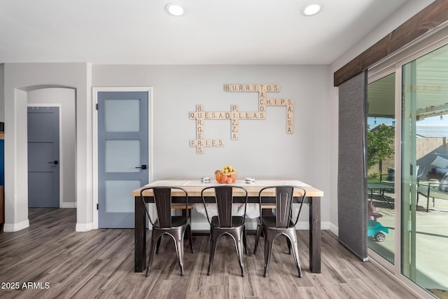 dining space with hardwood / wood-style flooring