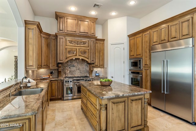 11320 N Crestview Dr, Fountain Hills, AZ 85268 - kitchen with visible vents, arched walkways, dark stone countertops, a sink, and built in appliances