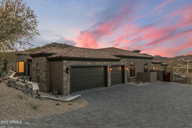 11320 N Crestview Dr, Fountain Hills, AZ 85268 - mediterranean / spanish-style house with stone siding, stucco siding, a tiled roof, decorative driveway, and a garage