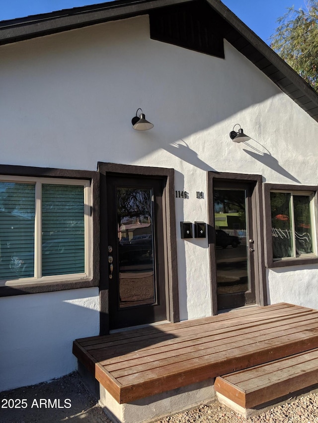 property entrance featuring stucco siding