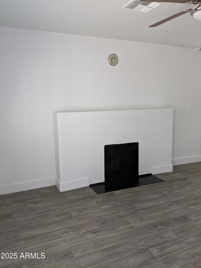 details with wood finished floors, a fireplace with flush hearth, visible vents, baseboards, and ceiling fan