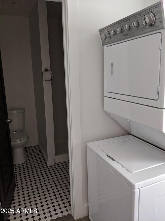 1145 E Portland St, Phoenix, AZ 85006 - clothes washing area with laundry area, stacked washing maching and dryer, and baseboards