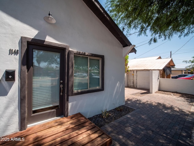 exterior space featuring stucco siding, fence, and a patio