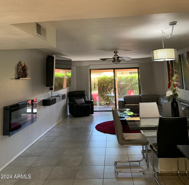 tiled living room with ceiling fan