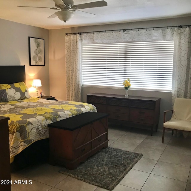 bedroom with ceiling fan and light tile patterned flooring