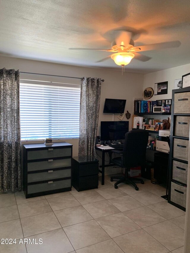 office with ceiling fan, plenty of natural light, a textured ceiling, and light tile patterned floors