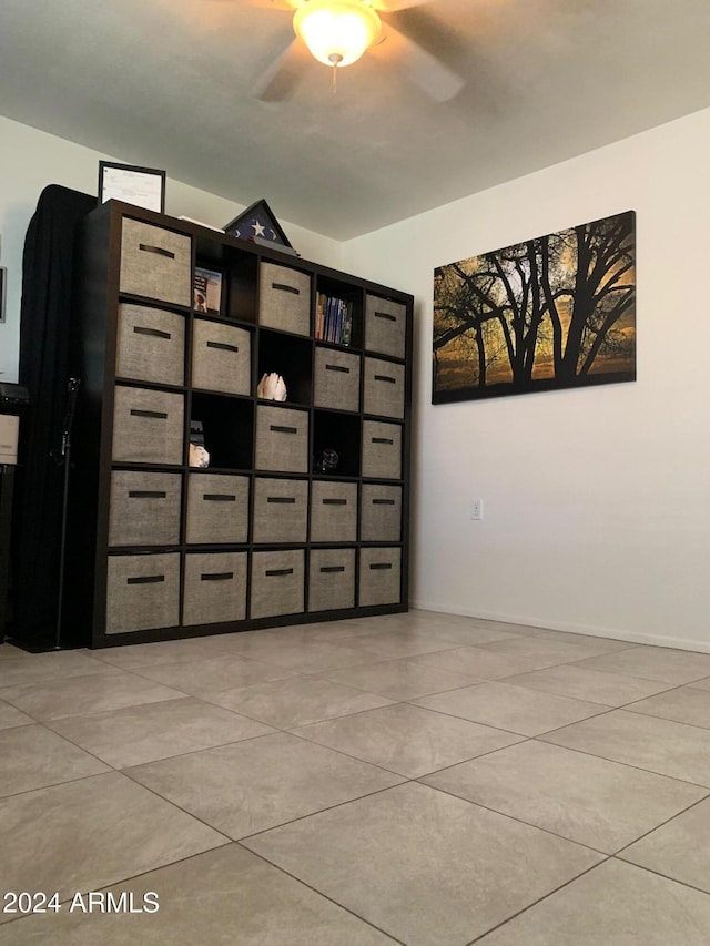 empty room with light tile patterned floors and ceiling fan