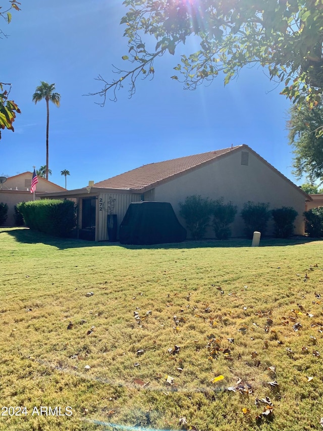 back of house with a lawn