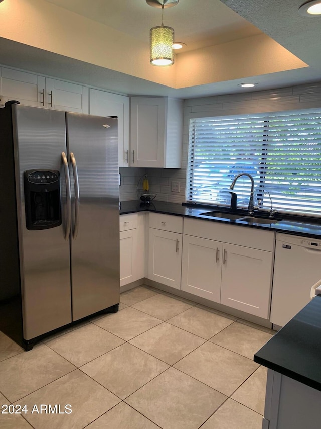 kitchen with stainless steel refrigerator with ice dispenser, sink, white cabinets, and white dishwasher