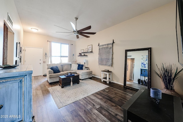 living area with a ceiling fan, baseboards, and wood finished floors