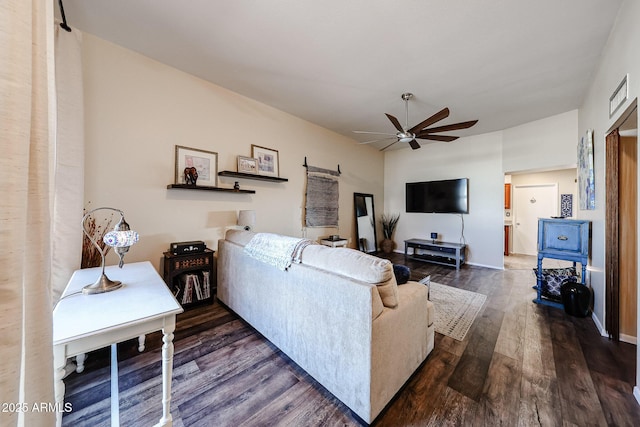 living room featuring ceiling fan, visible vents, and dark wood finished floors